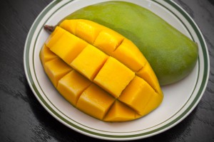 Yellow cubes sliced mango on white plate